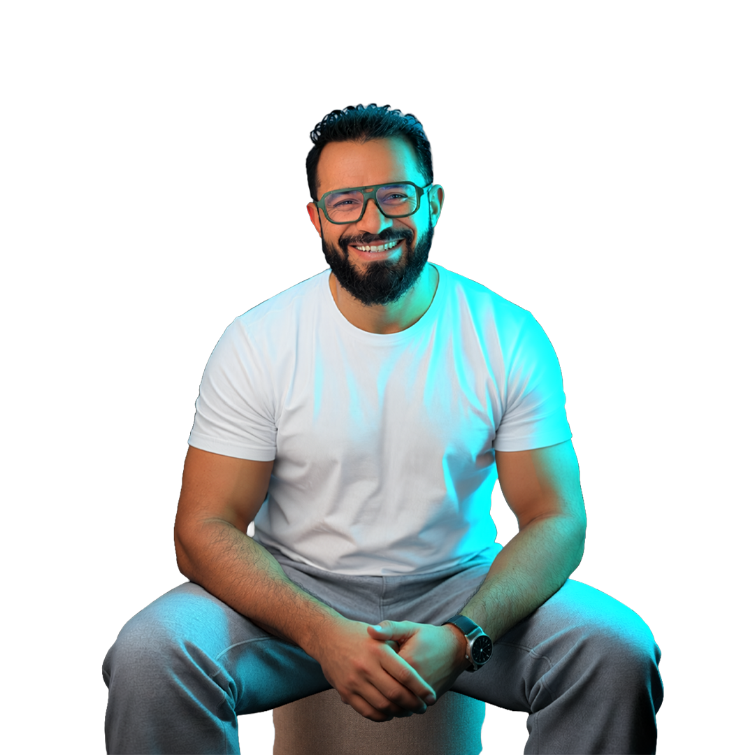 Mahmoud Gamal seated, smiling, in blue-cyan studio light